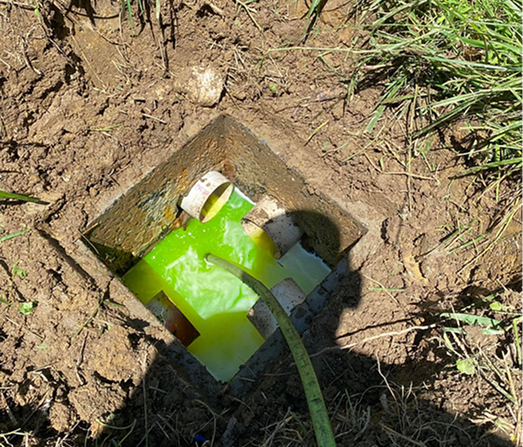 Technician performing professional septic inspection on residential property