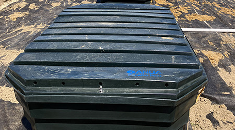 Technician installing a residential septic tank